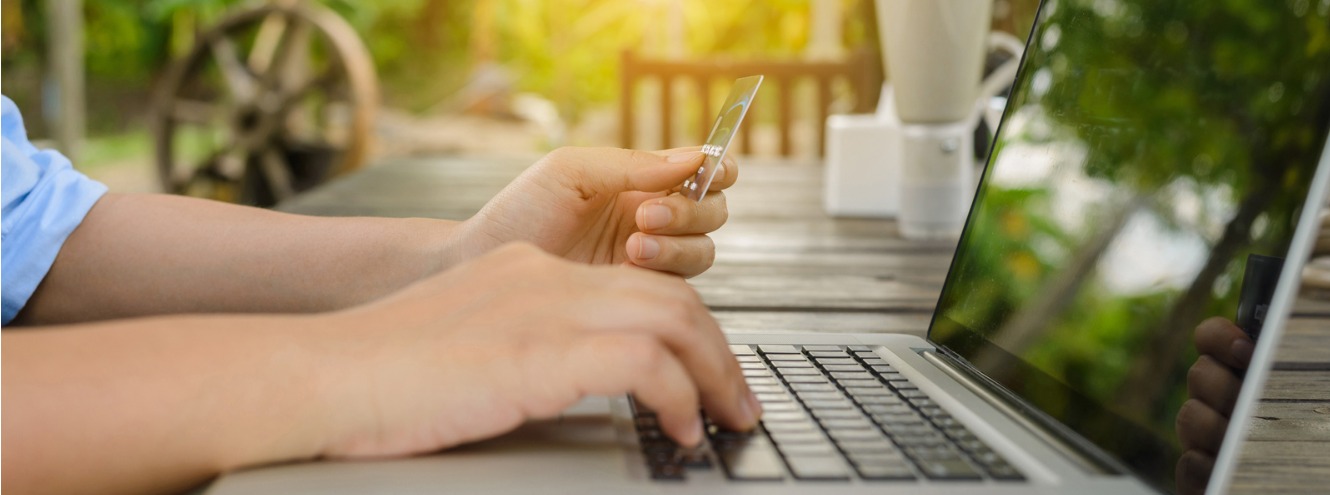 woman holding credit card in hand and entering security code using picture