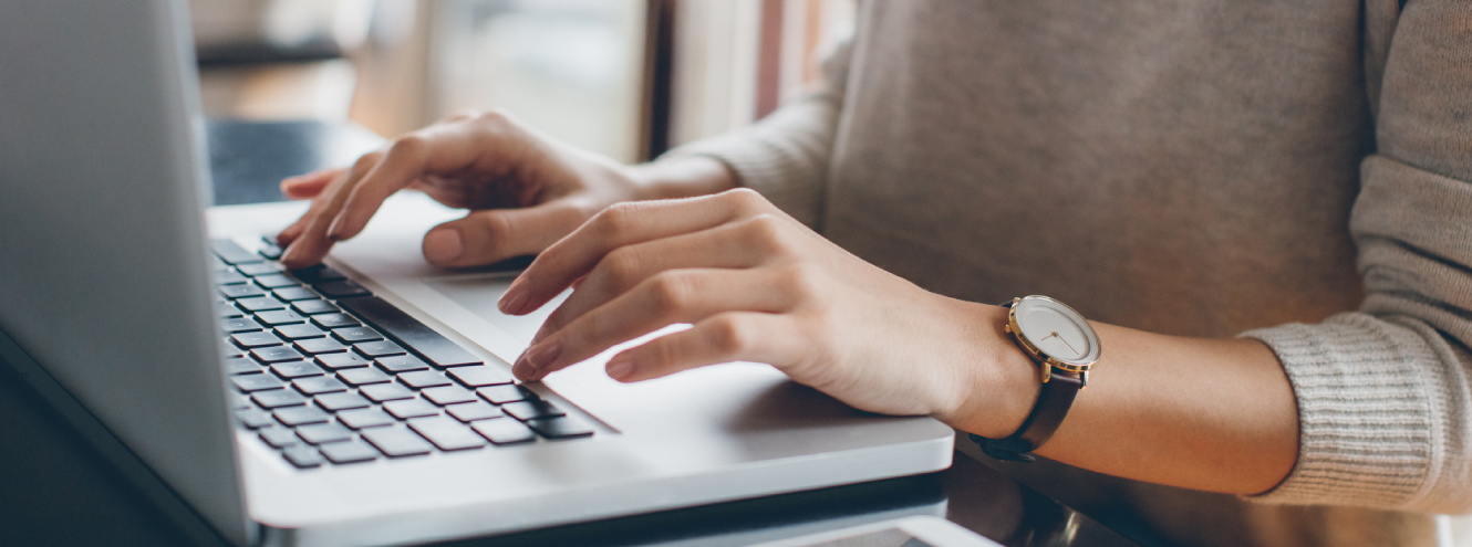 Woman typing on a laptop