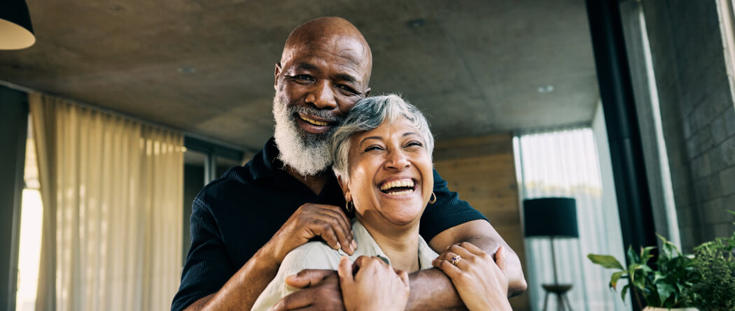 Mature couple hugging in a living room