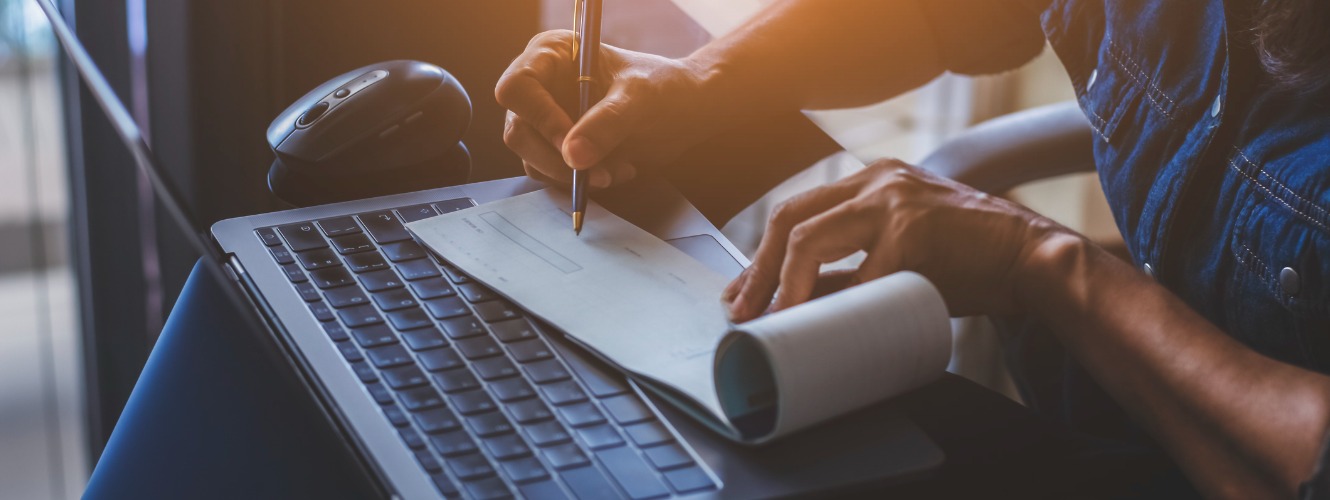 Business woman writing a check