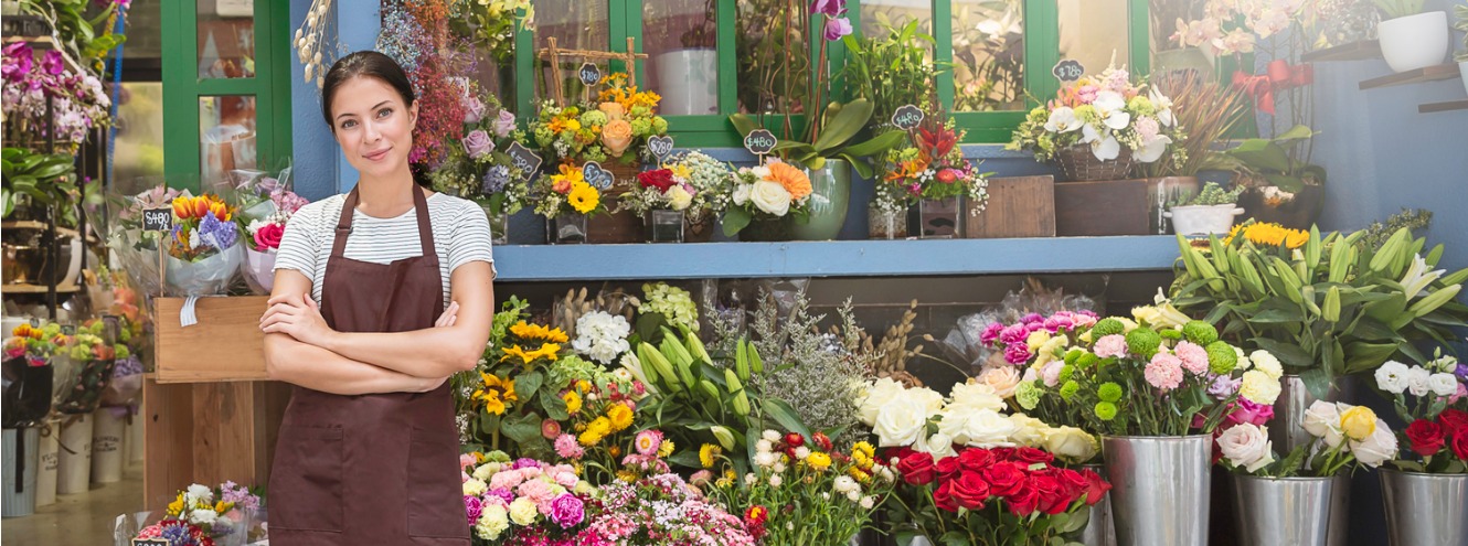 Business owner standing outside her shop. 