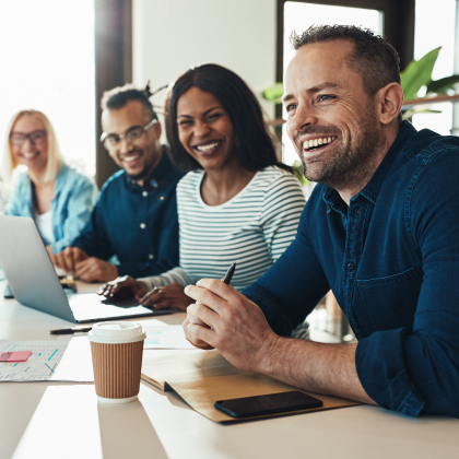 Table of coworkers smiling